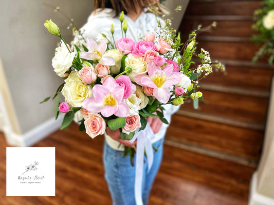 A classic round bridal bouquet with a mix of roses, lilies, and hydrangeas, exuding timeless beauty and grace, perfect for the traditional bride.